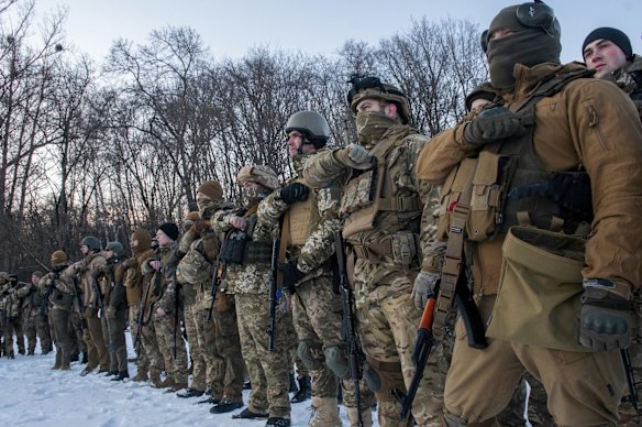 Ukrainian servicemen gesture during a training session outside Kharkiv,  