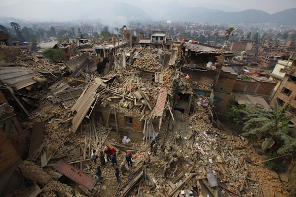 Rescue workers remove debris as they search for victims of earthquake in Bhaktapur near Kathmandu, Nepal, Sunday, April 26, 2015.