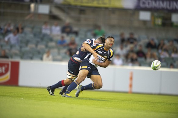Rebels' Richard Hardwick tackles the Brumbies' Irae Simone. 