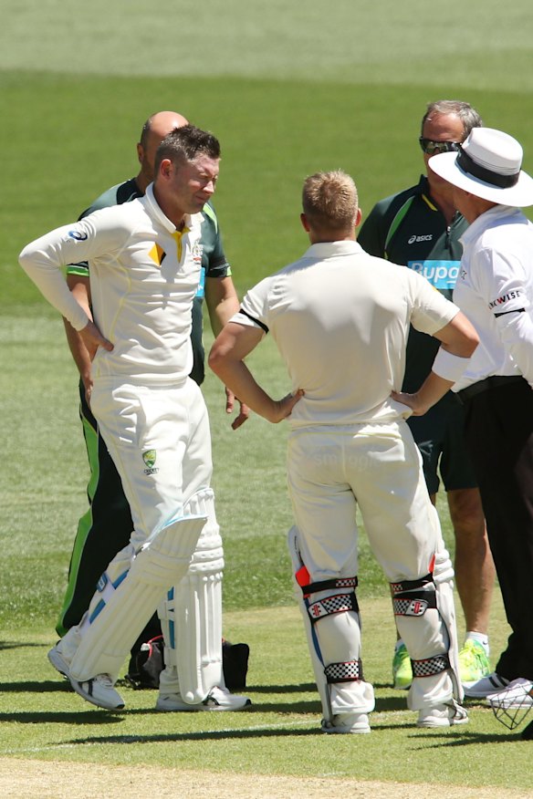 Michael Clarke of Australia reacts in pain shortly before leaving the field.