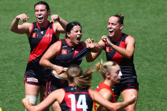 Taking a stand: Essendon star Maddy Prespakis points to her stomach in a show of pride after booting a goal on Sunday.