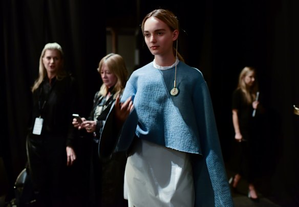 Models await their turn backstage.