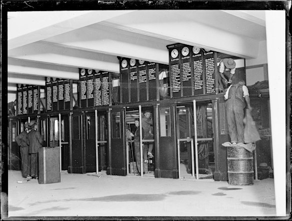 Workmen installing indicators at Wynyard railway station, New South Wales, 29 February 1927.
