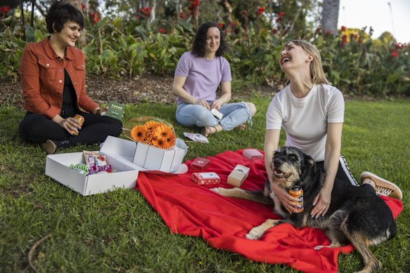 Masha, Raechyl, Leah and Buster the dog, from Darlinghurst enjoying a picnic at the Botanic Gardens, Sydney.