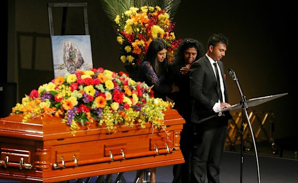 Brintha, Raji and Chinthu comfort each other during the service.