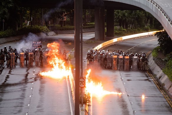 Demonstrators throw firebombs toward riot police during a protest in the Admiralty district.