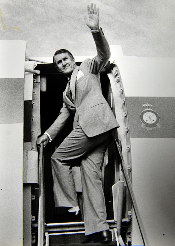 Former Prime Minister Malcolm Fraser waves farewell from his VIP plane at Fairbairn airport on his way to Japan. (18/4/78)