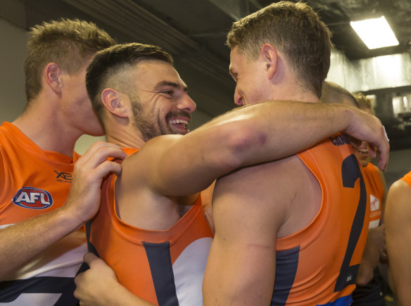 Spiritual leader: Stephen Coniglio embraces fellow midfielder Jacob Hopper after the win over Sydney.