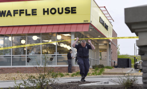 Law enforcement officials work at the scene of the fatal shooting.