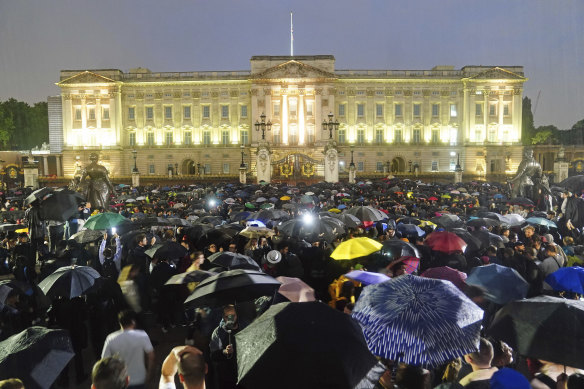 People gather outside Buckingham Palace following the announcement of the death of Queen Elizabeth II.