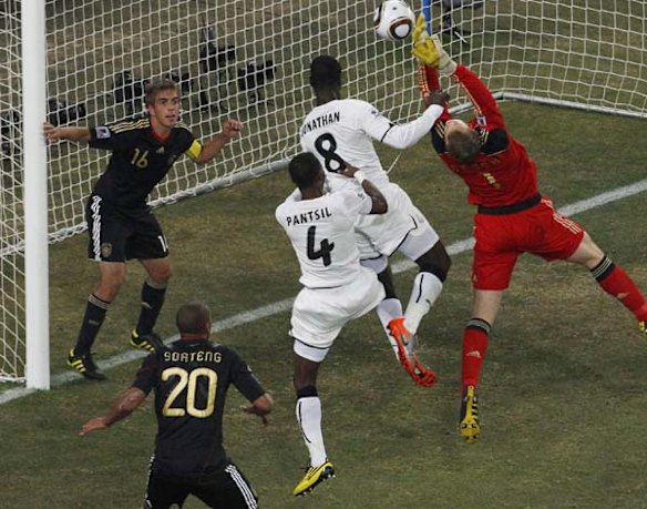 Germany's goalkeeper Manuel Neuer (R) makes a save next to Ghana's Jonathan Mensah (2nd R) and John Pantsil (3rd R).