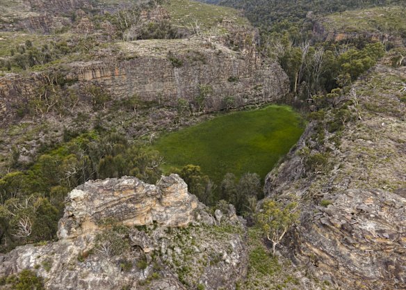 An aerial view of  Gooch's Crater near the Gardens of Stone National Park in Lithgow, Australia. Pink flannel flowers, which are blooming in the area, are extremely rare and only grow in scattered parts of eastern Australia, from the Blue Mountains to north-eastern Victoria.