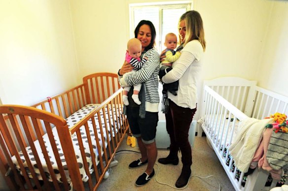 Canberra Capitals coach Carrie Graf, with partner Camille Chicheportische and baby twins Bentley (blue and yellow top) and Charli (blue and pink top).