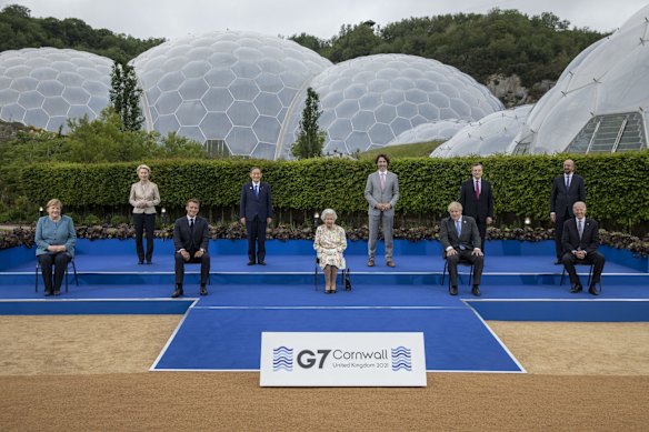 (L-R) German Chancellor Angela Merkel, European Commission Ursula von der Leyen, French President Emmanuel Macron,  Japanese Prime Minister Yoshihide Suga, Queen Elizabeth II, Canadian Prime Minister Justin Trudeau, British Prime Minister Boris Johnson, Italian Prime Minister Mario Draghi, President of the European Council Charles Michel and United States President Joe Biden pose for a group photo at a drinks reception for Queen Elizabeth II and G7 leaders at The Eden Project during the G7 Summit.