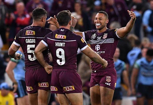 Moses Mbye of the Maroons celebrates with teammates winning Game 1.