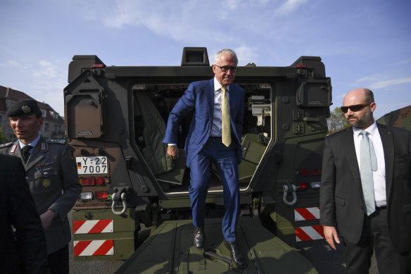 Malcolm Turnbull exits a Boxer  armoured fighting vehicle.