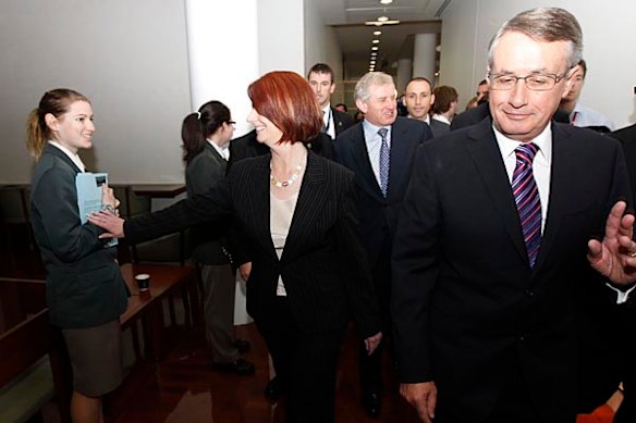 Julia Gillard, Wayne Swan and Simon Crean return to their offices after the vote at Parliament House.