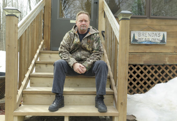 Shocked: Neighbour Wayne Sankey sits on the front steps of his Lakewood home.
