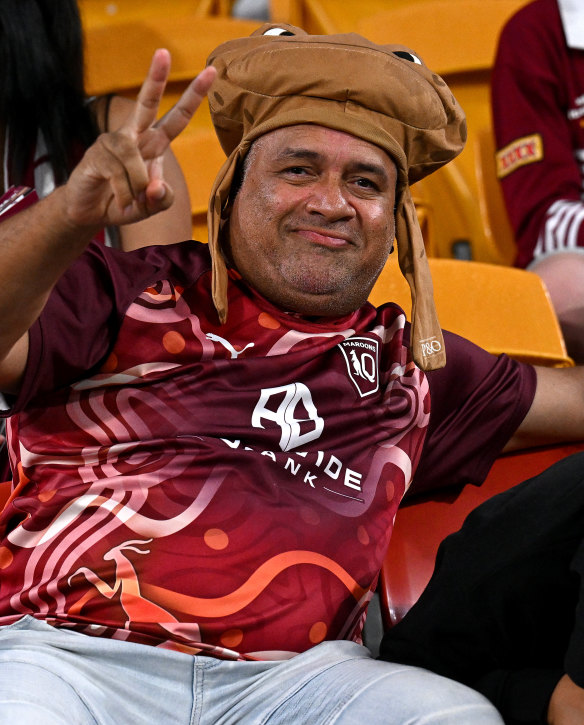 A Queensland fan waits for the match to start.
