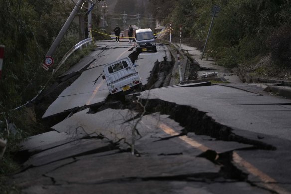 Passersby inspect damage near Noto on Tuesday.