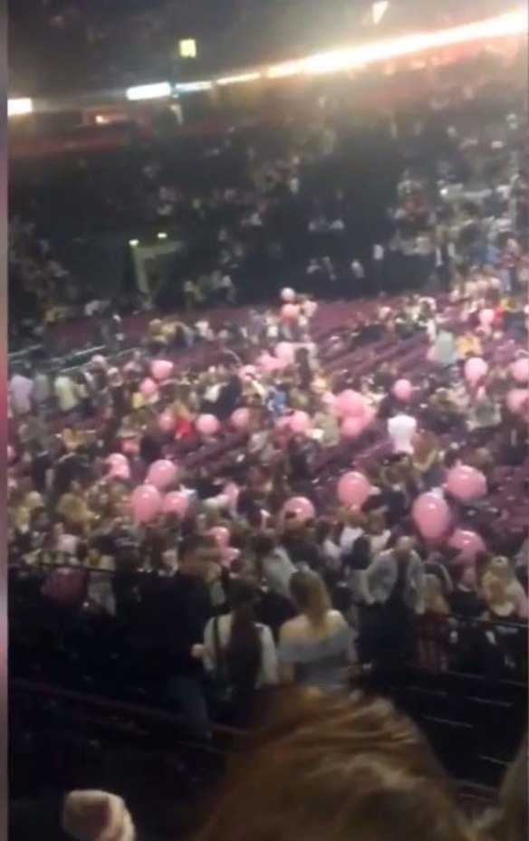 People rush for the exits at the Ariana Grande concert at the Manchester Arena.