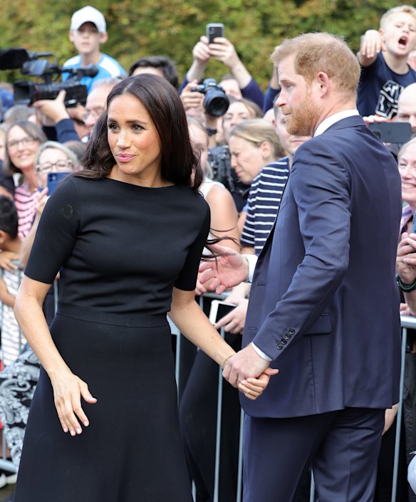 Meghan Duchess of Sussex and Prince Harry, Duke of Sussex speak with well-wishers at Windsor Castle.
