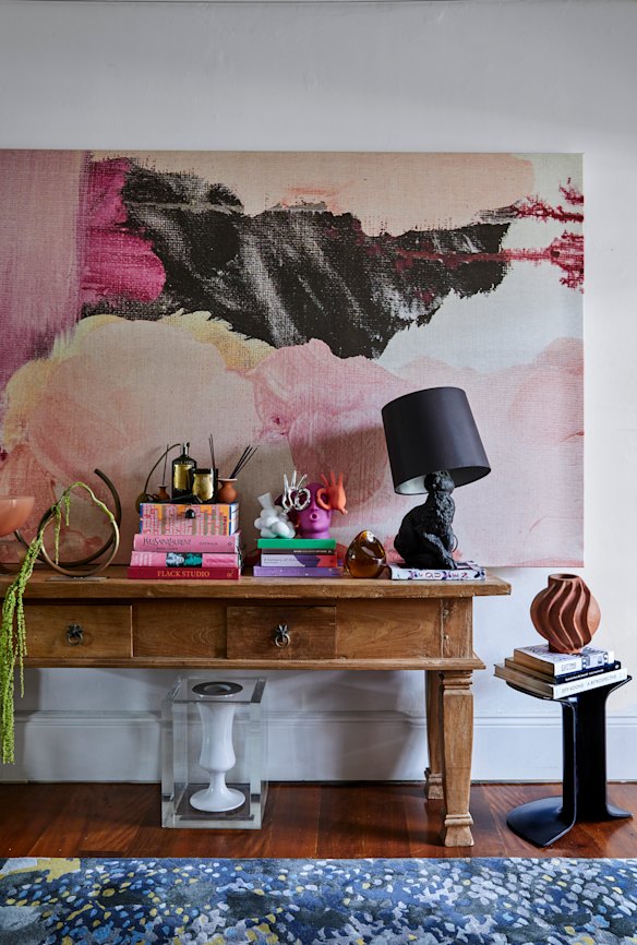 The entry features Coffey’s cased vase and hall runner on the floor, a Moooi “Rabbit Table Lamp”, a Charles Wilson “Serif ” stool and artwork by Shilo Engelbrecht.