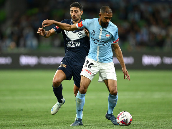 Nikos Vergos of Melbourne Victory and Samuel Souprayen of Melbourne City compete for the ball.