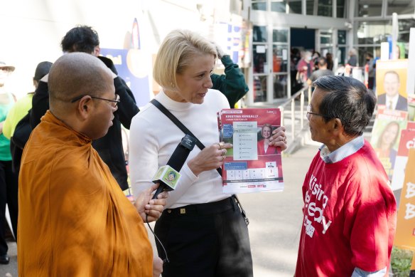 Labor candidate Kristina Keneally handing out how-to-vote cards in Fowler.