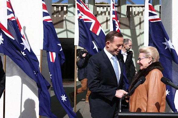 Prime Minister Tony Abbott greets Speaker Bronwyn Bishop after the National Flag Day ceremony at Parliament House in Canberra on Wednesday 3rd of September,  2014. 