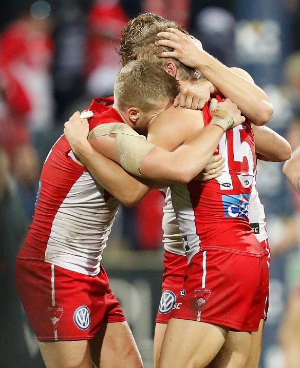 Kieren Jack (right) celebrates his 200th game earlier this year with Dane Rampe and Dan Hannebery.