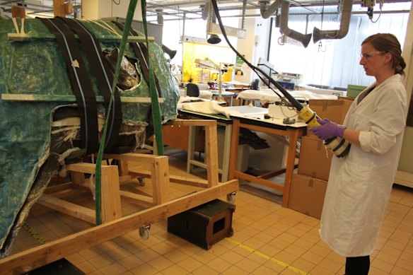 The conservation team works on the insides of the Sunfish.