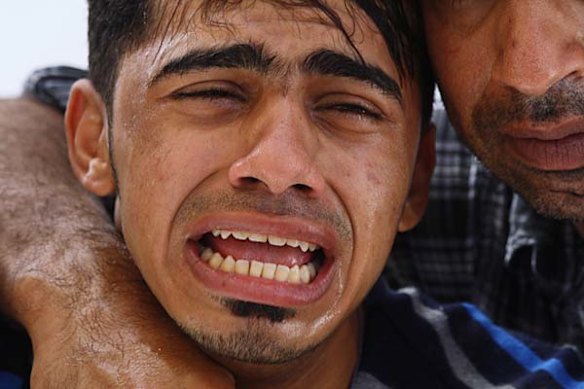 A family member cries out at a funeral of an anti-government protester in Sitra, Bahrain.