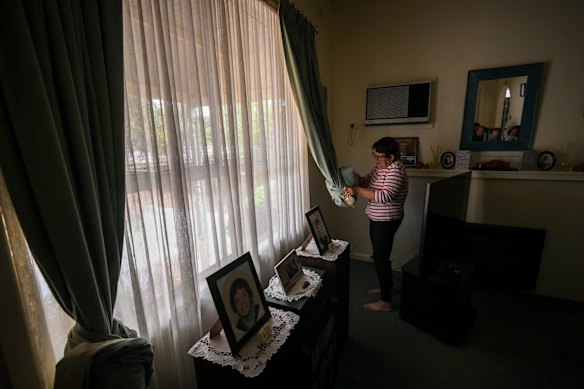 Glenys folding up the curtains to keep them out of the flood water.