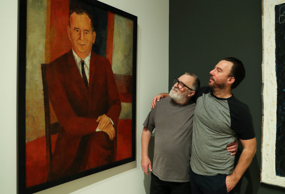 Three generations of Noffs: Wesley Noffs (centre) with a portrait of his father Ted and son Matt (right) at the Art Gallery of NSW.