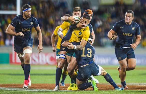  Pumas lock Guido Petti tries to slow a bustling run from Wallabies fullback Israel Folau.