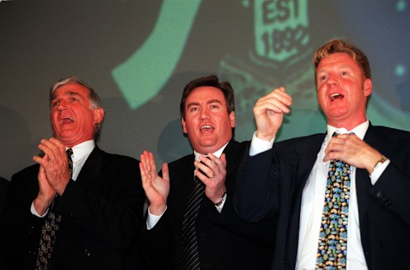 The new Collingwood President Eddie McGuire singing the club song with Brad Collins on his right and Kevin Rose on his left in 1998.