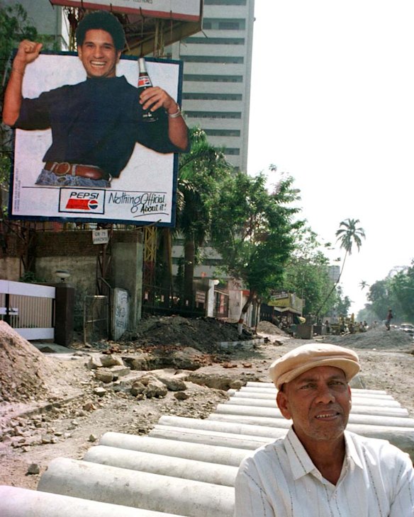 1996. larger than life. In the foreground is Ramakant Archarekar, described as a "mentor and guiding hand" to Tendulkar. 