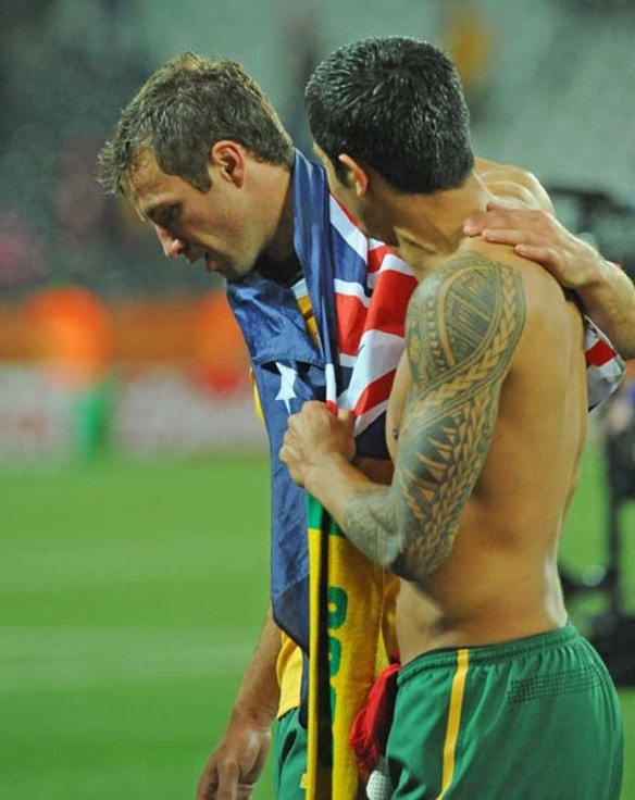 A shattered Tim Cahill and Lucas Neill after they won the match 2-1 but failed to progress to the next stage.