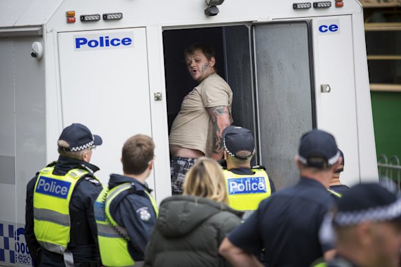 Police dragged another protester out of the crowd and placed him in a police van.