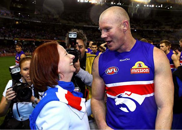 Julia Gillard celebrates with Western Bulldogs full-forward Barry Hall after the club's sensational win yesterday.