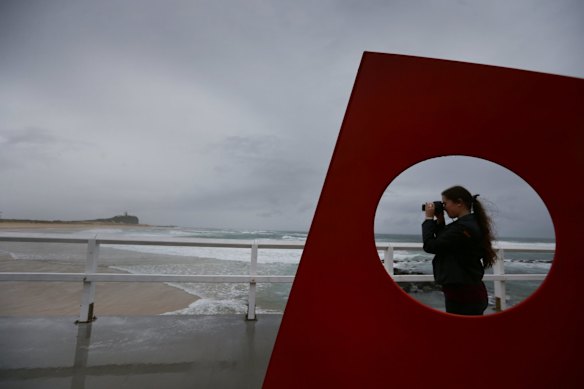 People braving the weather at Nobbys Beach, Newcastle, where in June 2007 the Pasher Bulker ran aground on the beach.