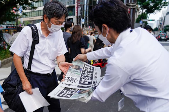 Extra editions of newspapers are handed out to the public in Tokyo, Japan.