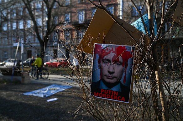 Banners left after protests against the Russian invasion of Ukraine lay on a fence in front of the Russian consulate in Krakow, Poland. 