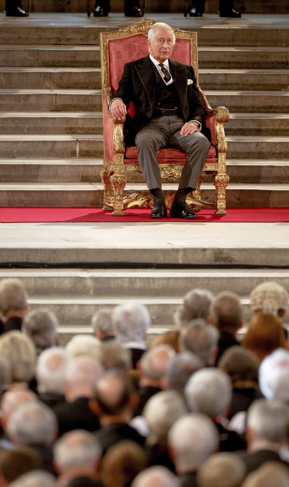 King Charles III sits in Westminster Hall.