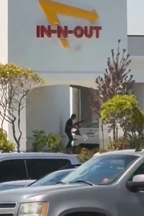A still image captured from video by a witness shows the scene of a shooting that started at an In-N-Out Burger restaurant.