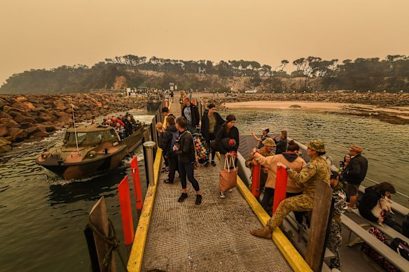 People stranded in Mallacoota are evacuated on to the HMAS Choules.