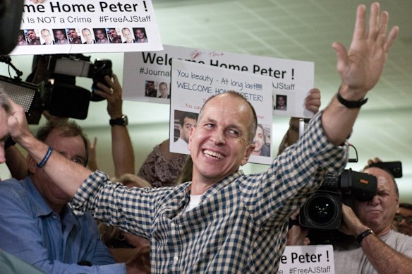 Peter Greste greets his supporters and the media after landing back in Australia at Brisbane Airport.