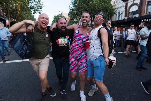 Crowds march down Oxford St, Darlinghurst this evening to celebrate the majority yes vote of the results of the postal vote.