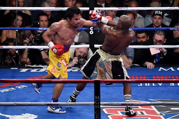 Manny throws a left at Floyd.